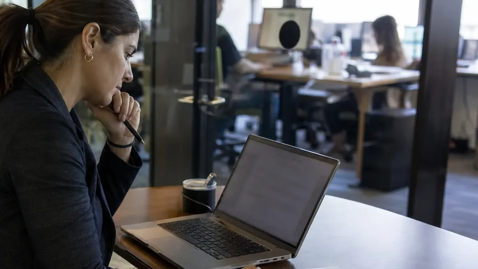 Operations manager reviewing an order form on her laptop before sending it for signature